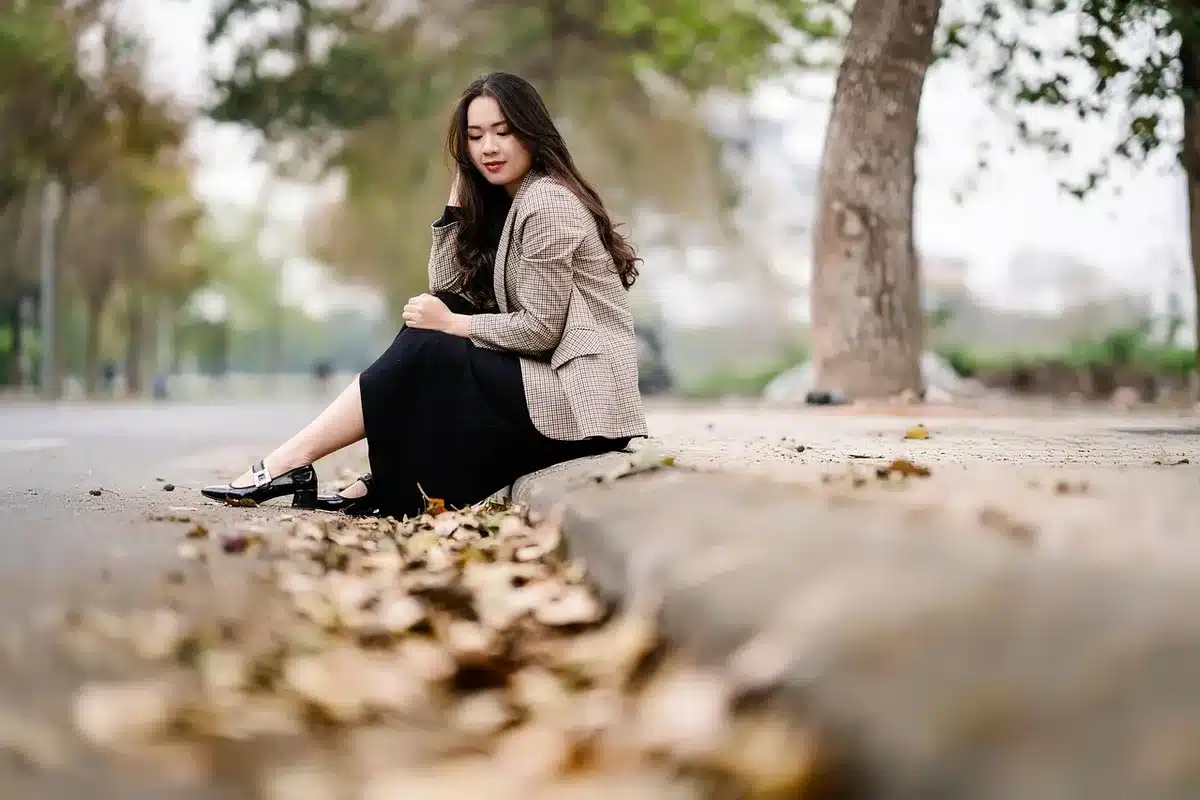 Woman wearing chunky sneakers with cropped trousers and blazer