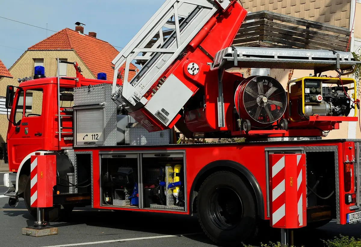 Fire engine and emergency crews at the side of a motorway in daylight