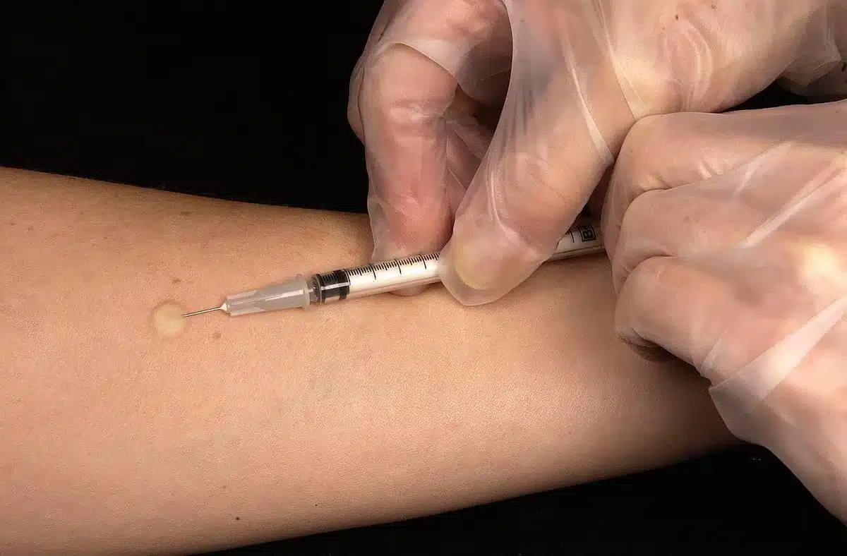 Once-weekly injectable pen on a clinic table next to informational leaflet