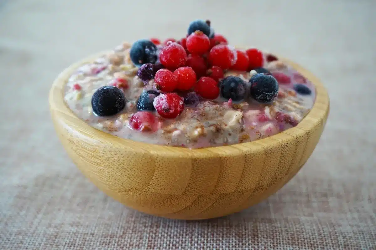 Bowl of ripe peaches and blueberries on a sunny kitchen table