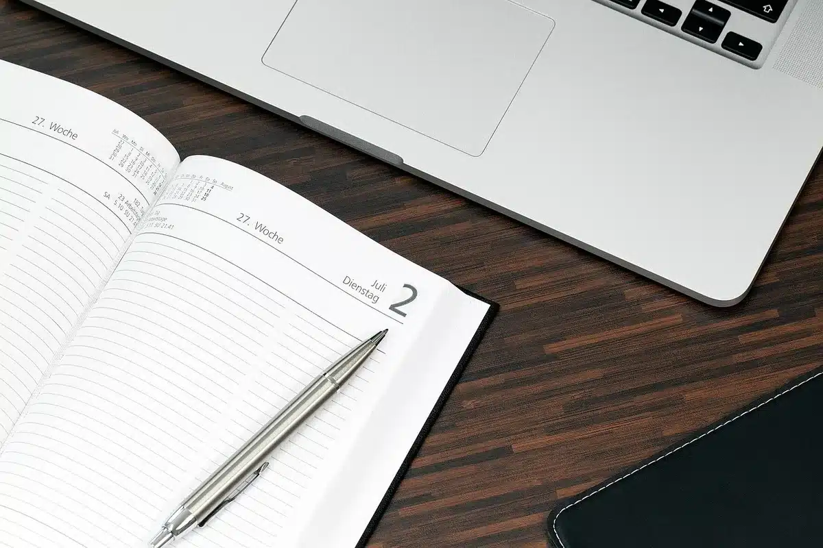 Notebook with menstrual cycle tracking and a pen on a table