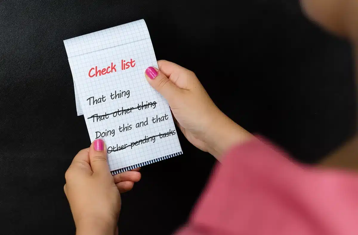 Printed checklist and pen on a clinic desk ready for a doctor's visit