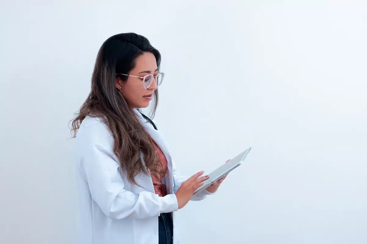Clinician discussing risks with patient using a clipboard in daylight clinic