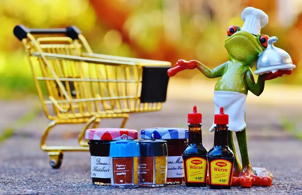 Shopping basket with packets of bacon and ham and other groceries