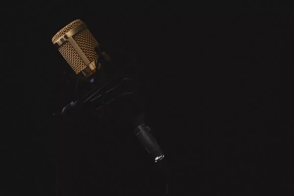 Close-up of a microphone and script in a bright recording studio