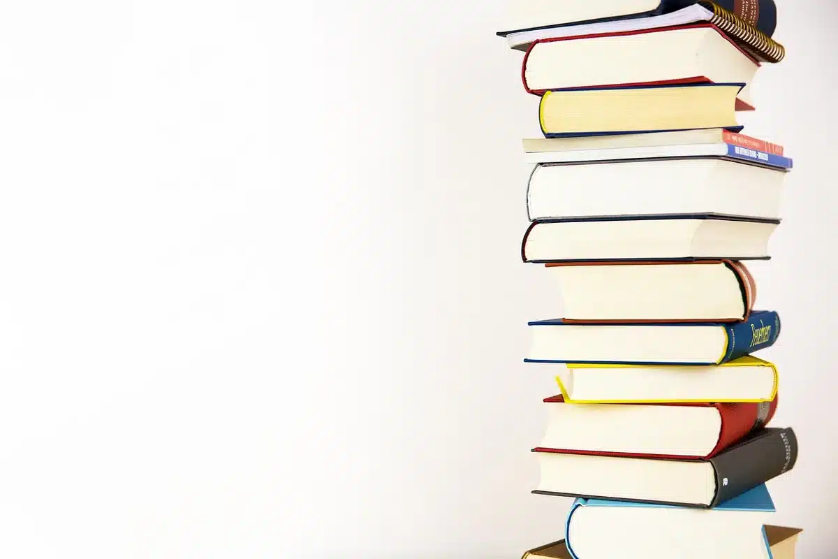 Open books and notes about symbolism on a sunlit table
